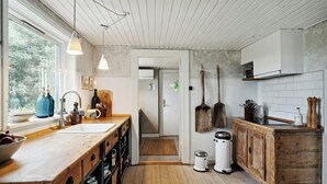 A kitchen with wooden countertops, a large window, and a view of the outdoors. - Nature-close home near beach at Limfjorden (Thyholm)