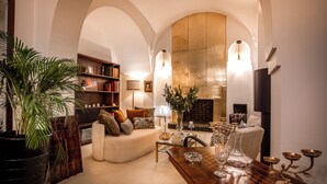 A cozy living room with a sofa, coffee table, and a fireplace. - Riad Anaqa (Marrakech)