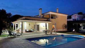 A two-story house with a swimming pool, outdoor seating, and a covered patio. - Luxury Villa on Prata Costa With Private Pool, Terrace With Lagoon View (Caldas da Rainha)