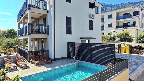 A modern building with a pool, balconies, and a mountain view. - #1 Holiday Apartment MTG - Orebić (Orebić)