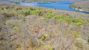 A lake surrounded by forested hills. - New! Lake Area Chalet w/ Hot Tub (Swanton)