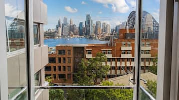 A balcony with a city view, including a body of water and buildings.