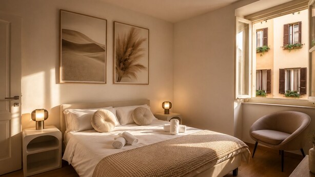 Un dormitorio con cama, mesitas de noche, una silla y una ventana con plantas.
