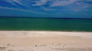 A beach with clear turquoise water and a sandy shore. - Riviera Club 1103 - Direct Beach Access (Fort Myers Beach)
