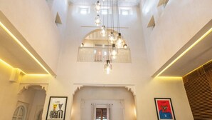A spacious interior with a high ceiling, a central chandelier, and a marble floor. - Villa Aurea (Marrakech)