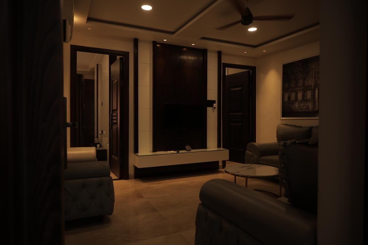 Una sala de estar moderna con chimenea, asientos y ventilador de techo.