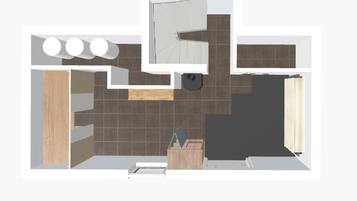 A bathroom layout with a shower, toilet, sink, and a mirror.