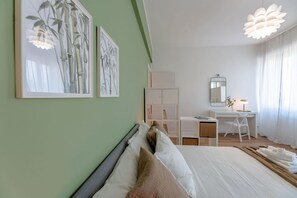A bedroom with a bed, a desk, a chair, and artwork on the wall. - [Penthouse panoramic view] Sea 3 min • A/C • WiFi (Albisola Superiore)