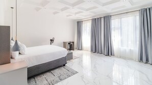 A modern bedroom with a large bed, a desk, and a chair. - Boutique Hotel-Style Room In Ferndale-G7 (Randburg)