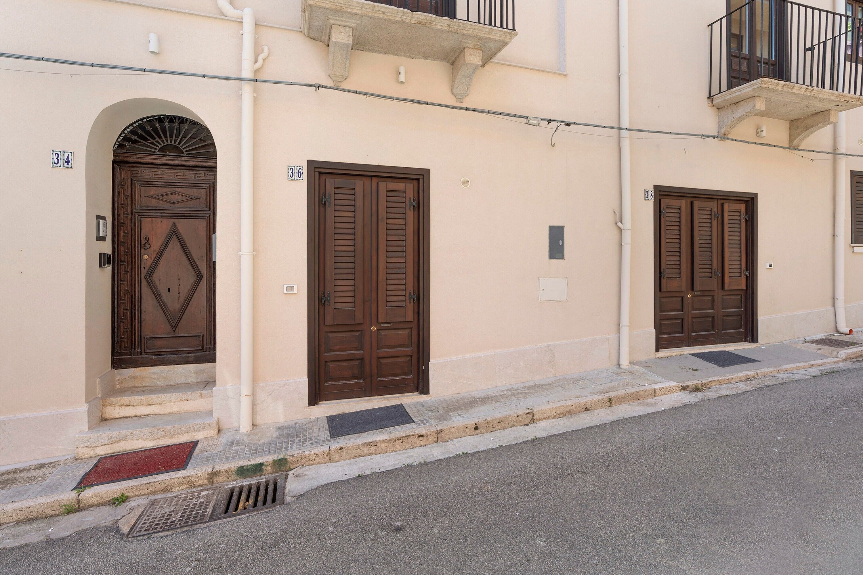 A building with three doors, each with a number above it.