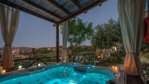 A hot tub with a view of the countryside, surrounded by a pergola and candles. - Altair Blue Villa - Private Jacuzzi and Views (Kalo Chorio)