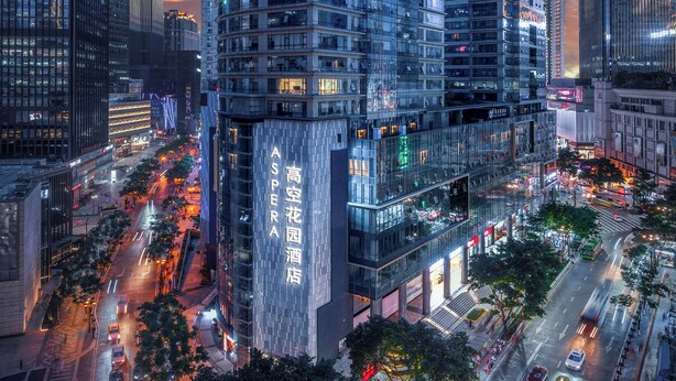 A high-rise building with multiple floors, large windows, and a prominent entrance. - ASPERA HIGH-ALTITUDE GARDEN PANORAMIC (Chongqing)