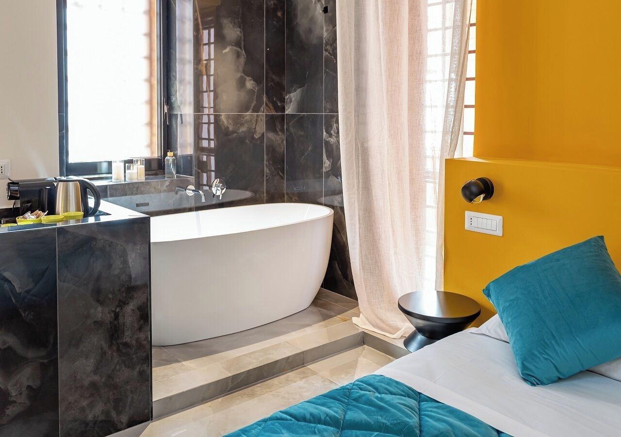 A modern bathroom with a freestanding bathtub, a vanity with a mirror, and a sink.