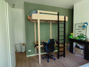 A bunk bed with a desk and chair, a ladder, and a shelf with toys and a sign. - Large, luxurious family home in Haarlem, close to city, beach and Amsterdam. (Haarlem)