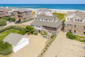 A coastal residential area with houses, a pier, and a beach. - JL #426 | J. Jones - Oceanfront - Pet Friendly (Nags Head)