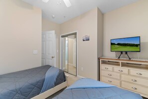 A bedroom with two beds, a television, and a dresser. - Family Friendly Coastal Escape (North Myrtle Beach)