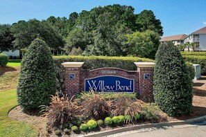 A sign for Willow Bend with a brick wall and greenery around. - Top-Floor Barefoot retreat | Nature views + Pool (North Myrtle Beach)
