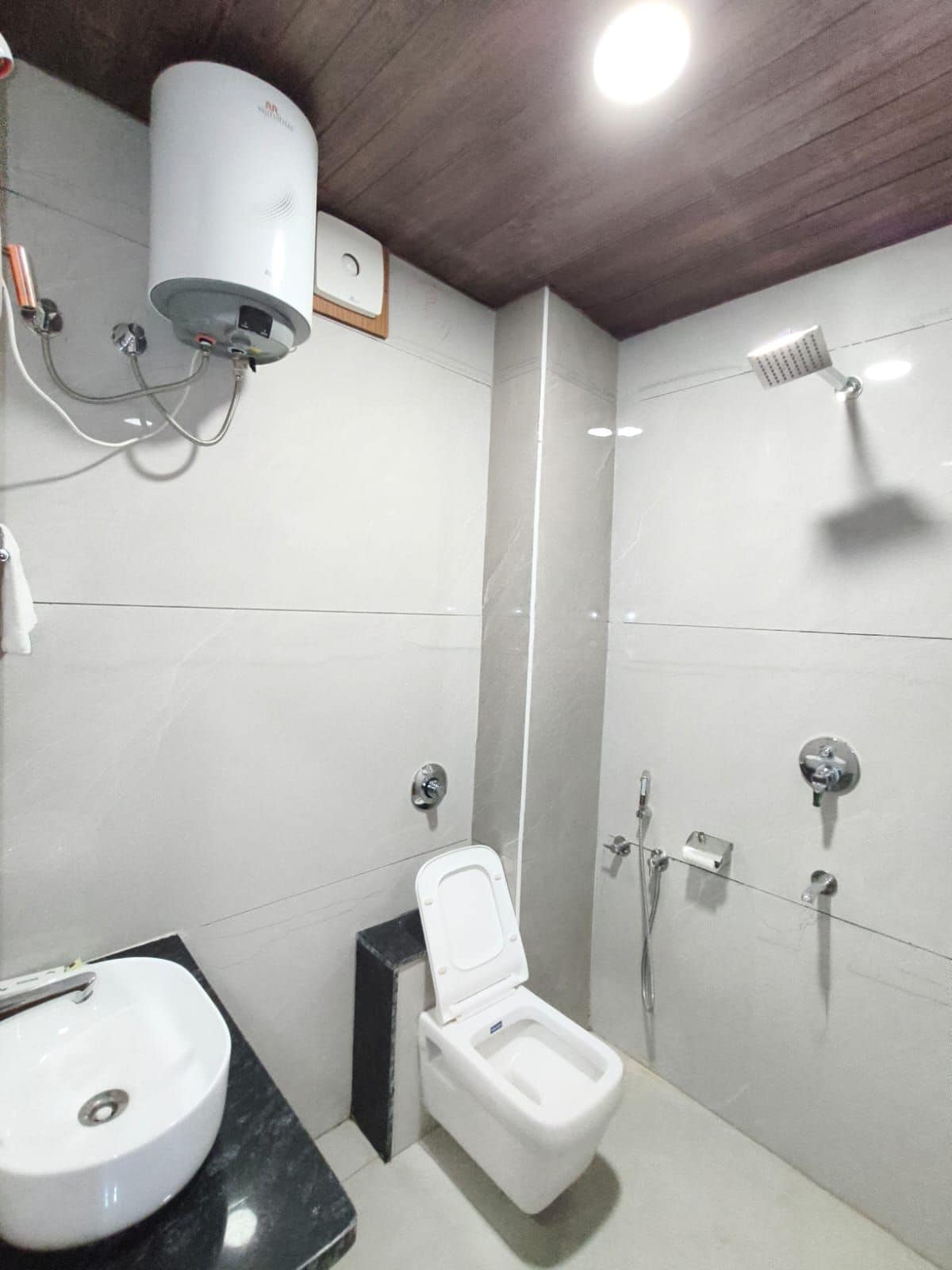 A modern bathroom with a toilet, sink, and shower.
