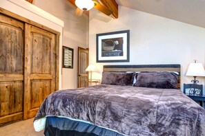 A bedroom with a large bed, wooden wardrobe, and a framed picture on the wall. - KBM Resorts | In the Heart of Old Town, Walk to Main St., Easy access shuttle to PCMR or DV Resorts, Private Hot Tub! POA-504b (Park City)
