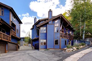 A two-story blue house with a balcony, a garage, and a driveway. - KBM Resorts | In the Heart of Old Town, Walk to Main St., Easy access shuttle to PCMR or DV Resorts, Private Hot Tub! POA-504b (Park City)