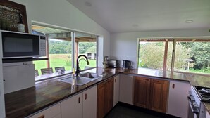 A modern kitchen with a built-in microwave, a sink, and a stove.