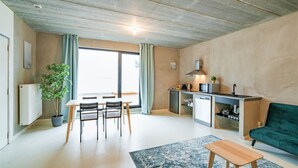 A compact living space with a dining area, kitchenette, and a sofa. - Antwerp Central Residence1bbknswifi (Antwerp)