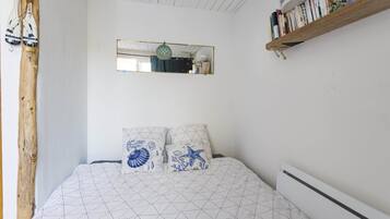 Tabla de planchar con plancha y ropa de cama