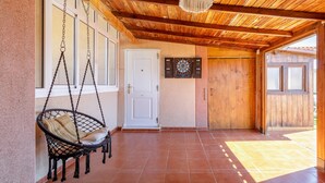 A wooden ceiling, a white door, a dartboard, and a hanging chair. - 'Nomad House' Apartment with Shared Pool, Wi-Fi, and Air Conditioning (Gran Alacant)