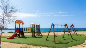 A playground with a slide, climbing structures, and swings. - Villa 'Relax Cabrera Miramar' (Colònia de Sant Jordi)