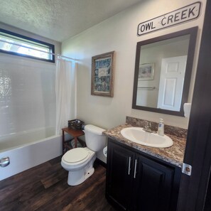 A bathroom with a bathtub, toilet, sink, and a mirror. - 4 Bedroom, 2 Bath Historical Homestead on the Bighorn River- Longwell Boat Ramp. (Thermopolis)