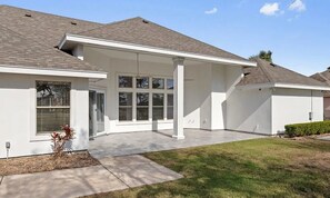 A modern single-story house with a covered patio, large windows, and a well-maintained lawn. - Spacious 4-bedroom home in Laguna Vista w/pool, pickleball, golf course and gym (Laguna Vista)