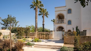 A building with a white facade, arched windows, and a balcony. - Apartment 'Don Onofrio - Domitilla' with Mountain View, Wi-Fi and Air Conditioning (Monopoli)