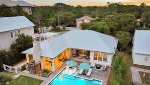 A residential property with a swimming pool, outdoor seating area, and a covered patio. - Retreat Close to Beachw/ Pool and Screened Porch (Santa Rosa Beach)