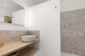 A bathroom with a white sink, wooden countertop, and a mirror above it. - Bed and Breakfast 'Suite Les Cabanes' with Shared Pool, Shared Garden and Wi-Fi (La Brée-les-Bains)