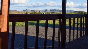 A wooden deck with a view of a mountainous landscape.
