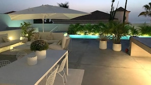 An outdoor patio area with a pool, seating, and potted plants. - Vacation Villa 'Esperanza' with Sea View, Wi-Fi and Air Conditioning (Costa Adeje)