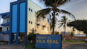 A modern building with a sign reading 'POUSADA VILA REAL'.