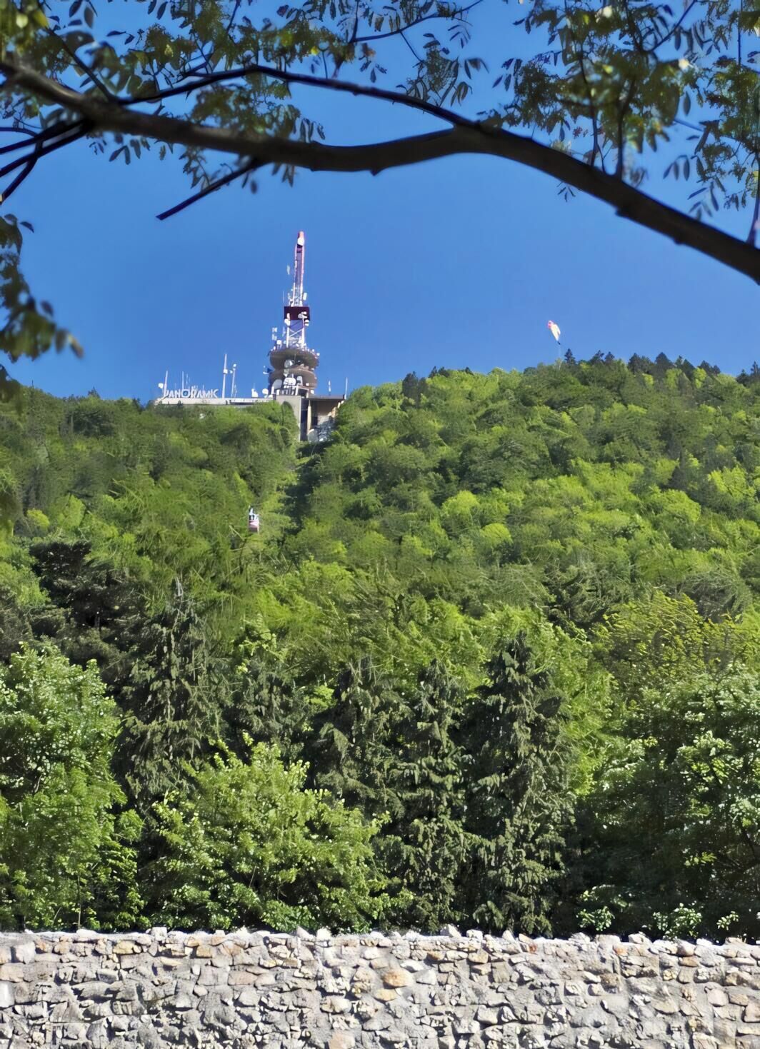 A mountainous landscape with a large tower structure.