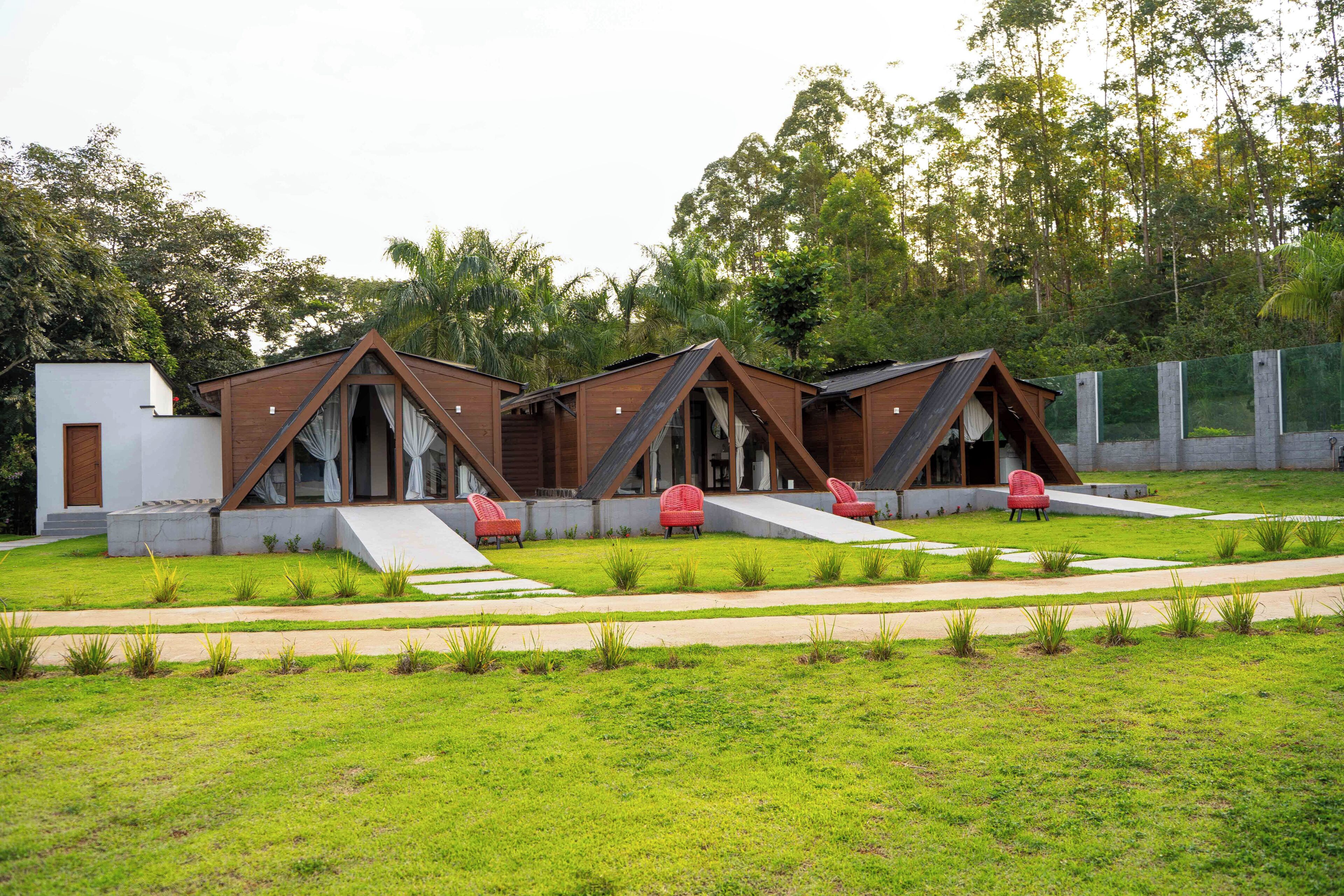 A modern building with multiple rooms, each with a sloped roof and large windows.