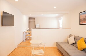 Family Studio | Desk, laptop workspace, blackout drapes, iron/ironing board