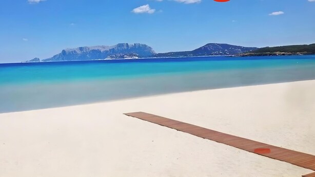 A beach with clear water and distant mountains. - Apartment 'Annina' with Private Terrace, Wi-Fi and Air Conditioning (Pittulongu)