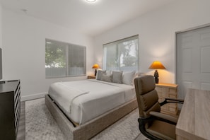 A bedroom with a bed, two bedside lamps, a chair, a desk, and a dresser. - 2BR Steps from Downtown  In-Unit Washer and Dryer (Miami)
