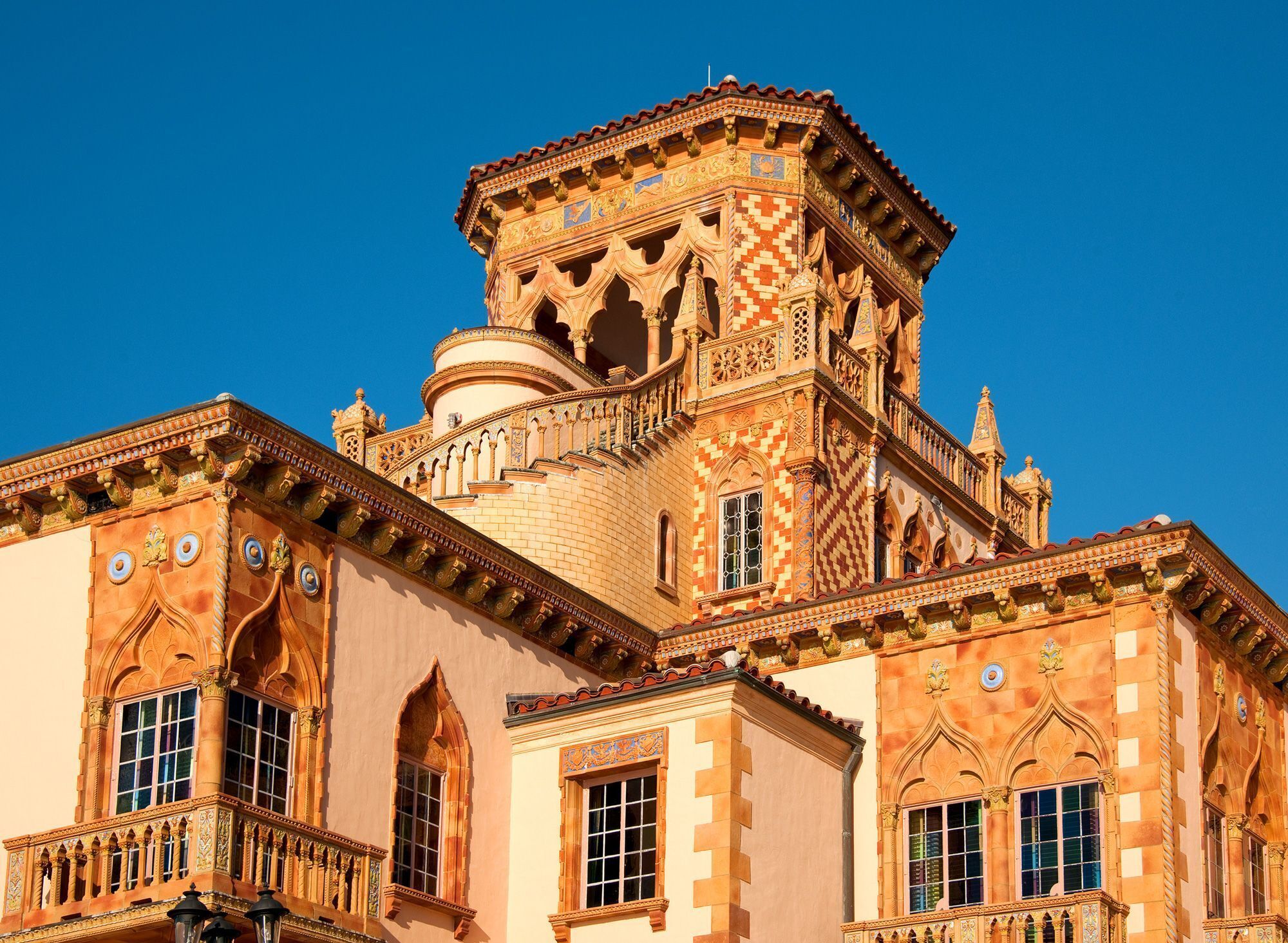 Um edifício histórico com detalhes arquitetônicos elaborados, incluindo janelas em arco e varandas ornamentadas.