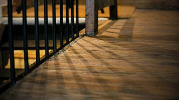 A wooden floor with a metal railing.