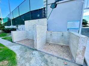 A swimming pool with a tiled interior and a sign indicating pool rules. - Charming Isla Verde with Pool & Beach Access (Carolina)