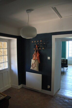 A room with a dark wall, a white radiator, a hanging light fixture, and a window. - Charming gite in Mont Saint Vincent (Mont-Saint-Vincent)