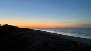 Een strand met een heldere lucht bij zonsondergang.