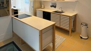 A modern kitchen with a built-in island, a sink, and overhead lighting. - Town house with sea view in historic Ærøskøbing (Ærøskøbing)