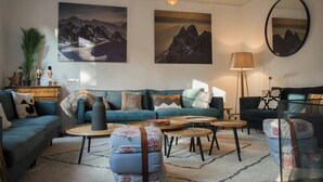 A living room with a sofa, coffee table, and a lamp. - Modern villa with spa in the heart of Alsace (Selestat)