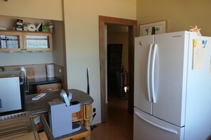 A kitchen with a refrigerator, microwave, and coffee maker. - World Cup? Beachfront suite, 0.5 hr + ferry ride to Seattle. (Seabeck)
